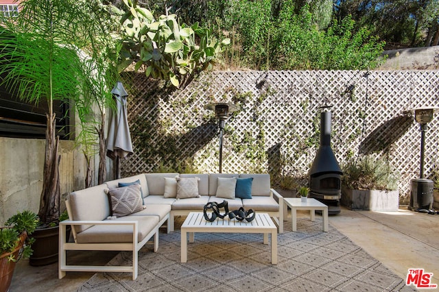 view of patio / terrace with an outdoor living space with a fireplace