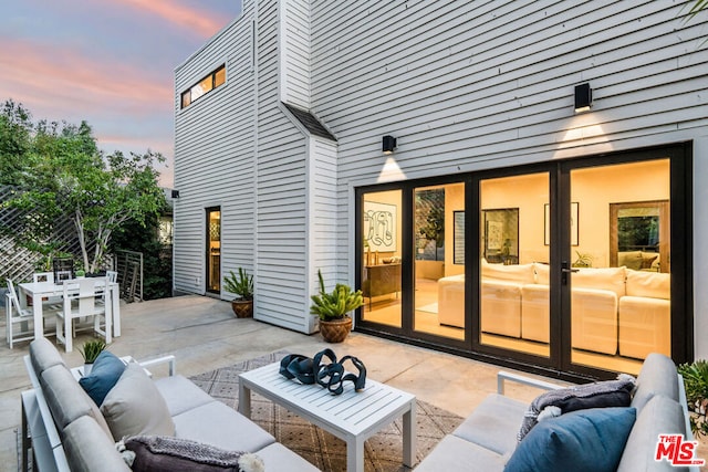 patio terrace at dusk featuring outdoor lounge area