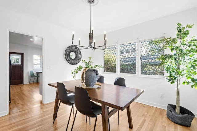 dining room featuring an inviting chandelier and light wood-type flooring