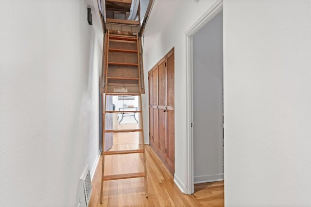 hall with light hardwood / wood-style floors