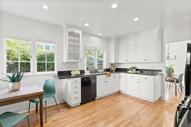 kitchen featuring white cabinetry, black appliances, and light hardwood / wood-style floors