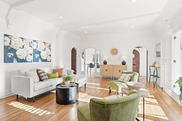 living room with vaulted ceiling and light hardwood / wood-style flooring