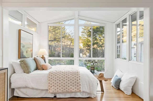 bedroom with wood-type flooring and lofted ceiling with beams