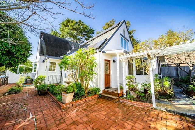 view of front of house with a patio area and a pergola