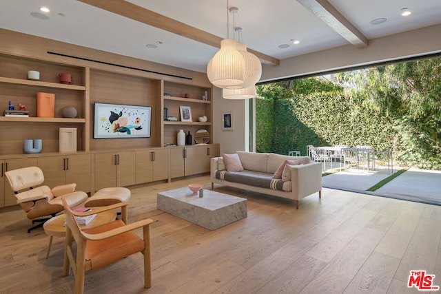 living room featuring light wood-type flooring, built in features, and beam ceiling