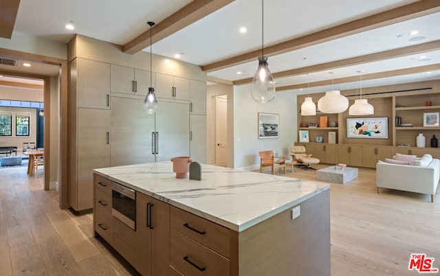 kitchen featuring pendant lighting, beamed ceiling, light wood-type flooring, built in microwave, and light stone counters