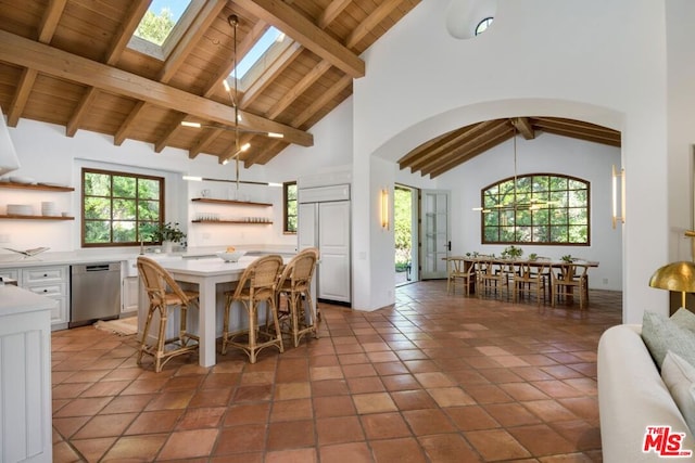 kitchen with wooden ceiling, beam ceiling, dishwasher, and high vaulted ceiling