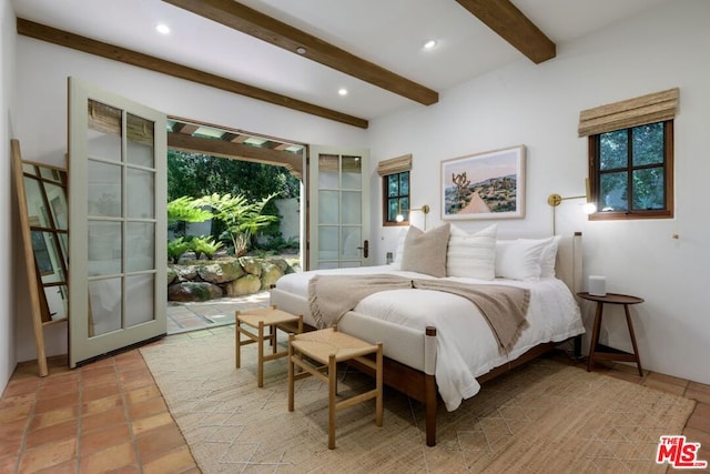 tiled bedroom featuring beam ceiling and french doors