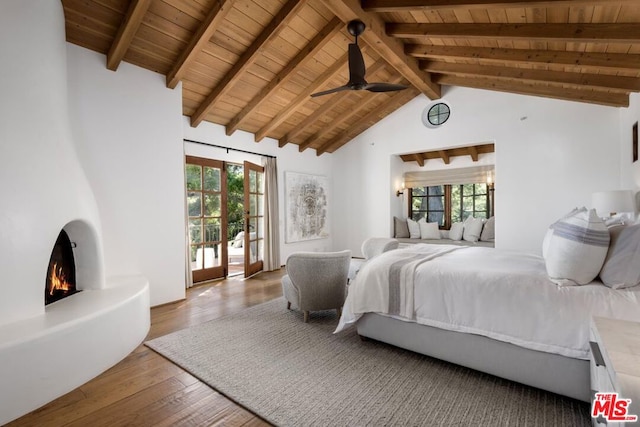 bedroom featuring ceiling fan, beamed ceiling, hardwood / wood-style flooring, and wooden ceiling