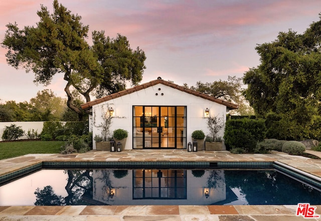 view of pool at dusk