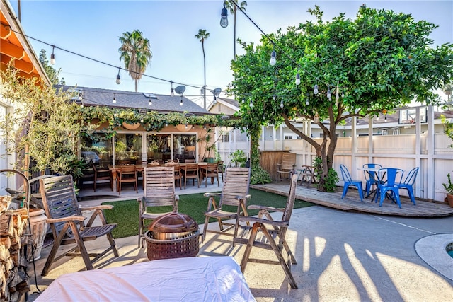 view of patio with a wooden deck and a fire pit