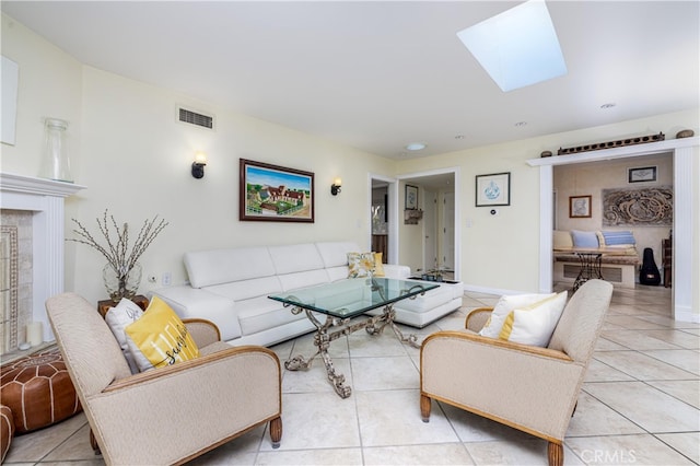 tiled living room with a skylight