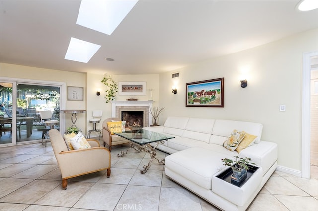 living room featuring light tile patterned floors and a skylight