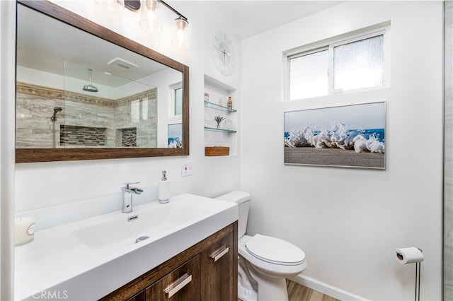 bathroom with a shower, toilet, and vanity