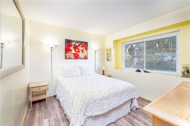 bedroom with wood-type flooring