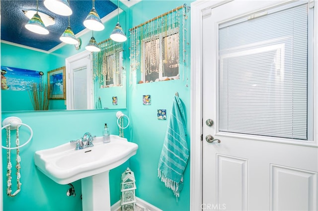 bathroom with a textured ceiling and crown molding