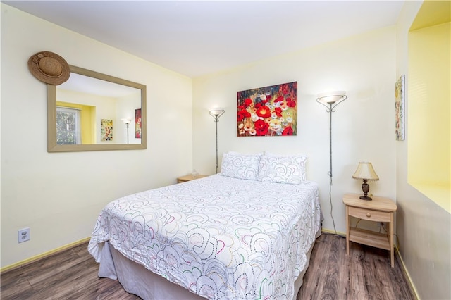 bedroom featuring dark hardwood / wood-style flooring