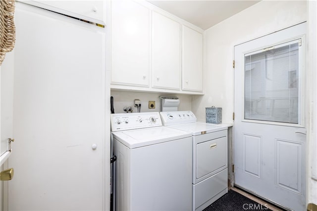 washroom featuring washer and dryer and cabinets