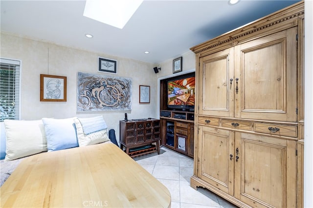 interior space with a skylight and light tile patterned flooring