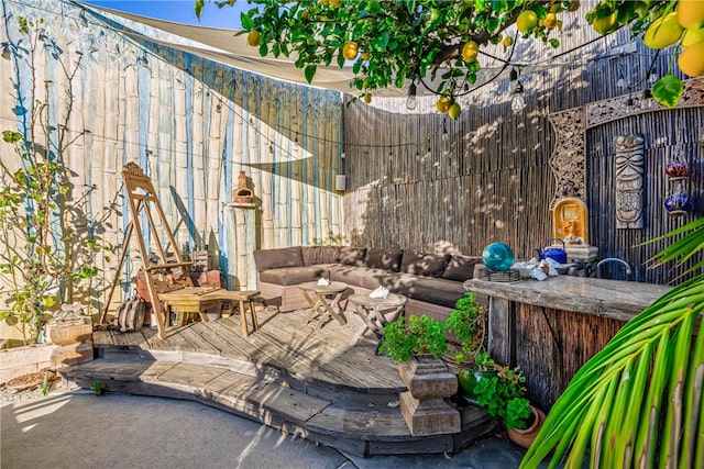 view of patio with a wooden deck and an outdoor living space