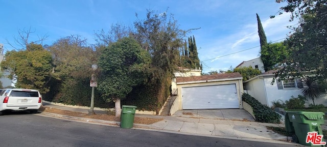 view of front of house with an outdoor structure and a garage