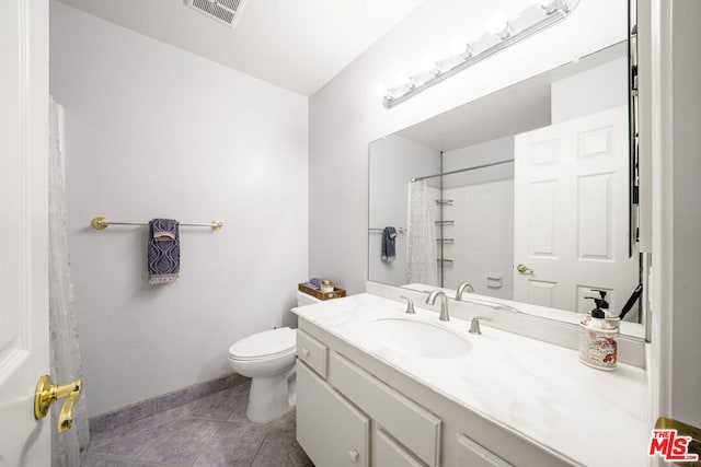 bathroom with toilet, tile patterned floors, walk in shower, and vanity