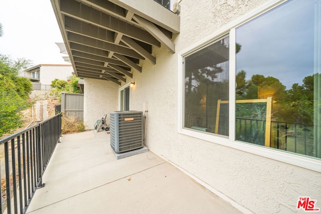 view of patio / terrace with a balcony and central AC unit