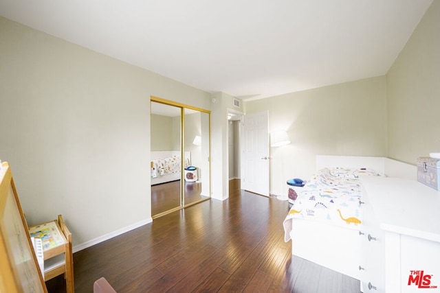 bedroom featuring a closet and dark hardwood / wood-style floors