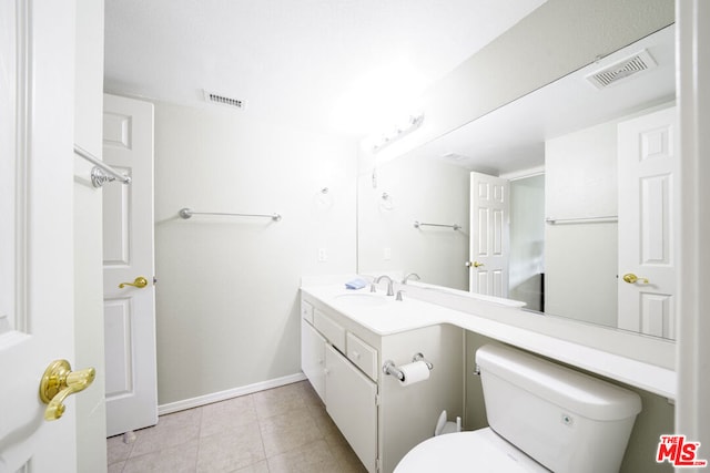 bathroom featuring toilet and vanity