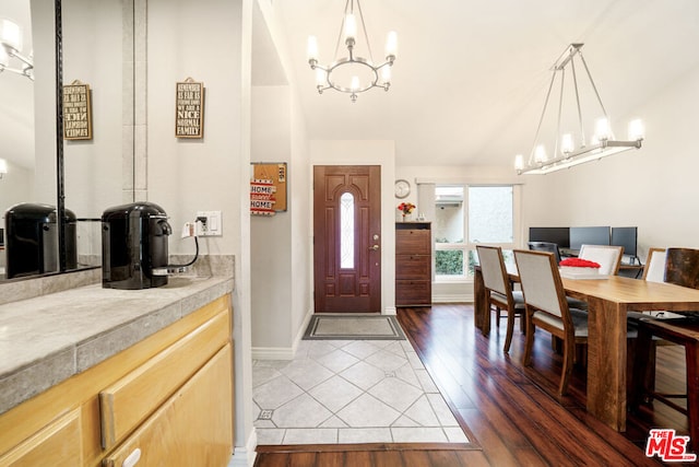 foyer featuring dark hardwood / wood-style floors and lofted ceiling