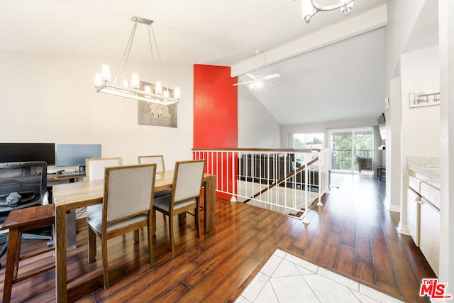 dining area featuring vaulted ceiling with beams, ceiling fan with notable chandelier, and hardwood / wood-style flooring