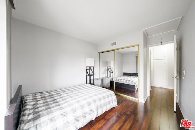 bedroom with a closet and hardwood / wood-style floors