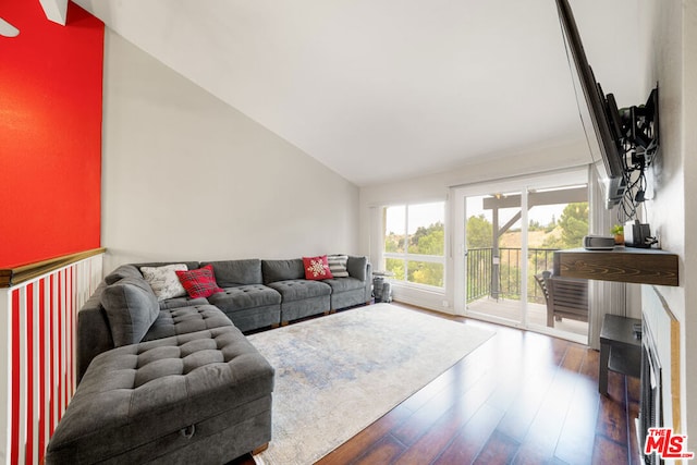 living room with vaulted ceiling and hardwood / wood-style floors