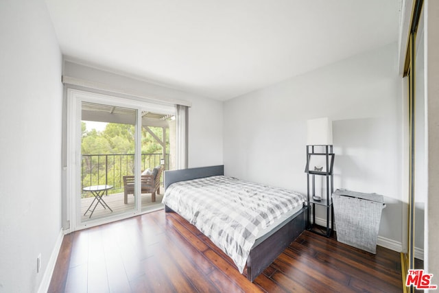 bedroom featuring access to exterior and dark hardwood / wood-style flooring