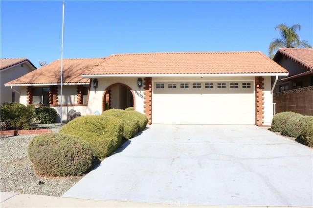 mediterranean / spanish-style house with a garage