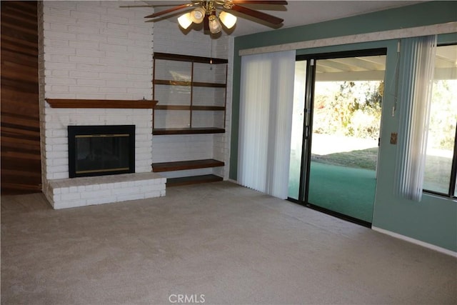 unfurnished living room with light carpet, ceiling fan, and a brick fireplace