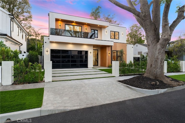 modern home with a balcony and a garage