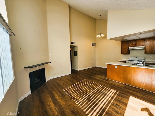 kitchen featuring gas range gas stove, a notable chandelier, sink, and dark hardwood / wood-style flooring