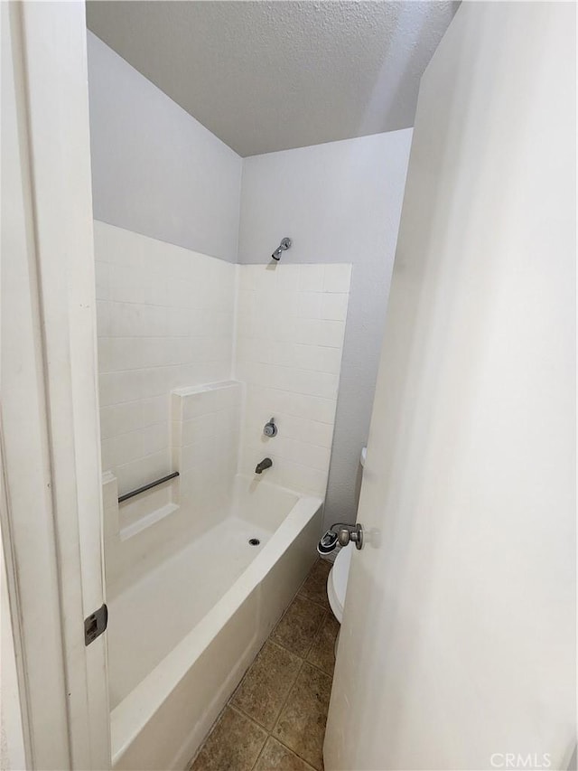 bathroom featuring a textured ceiling and toilet