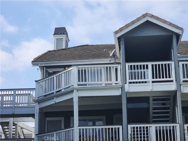 back of property featuring a balcony