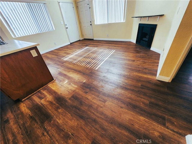 unfurnished living room featuring dark hardwood / wood-style flooring