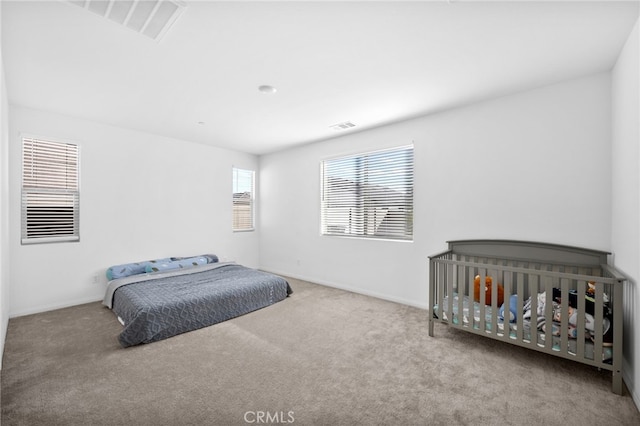 bedroom featuring carpet, visible vents, and baseboards