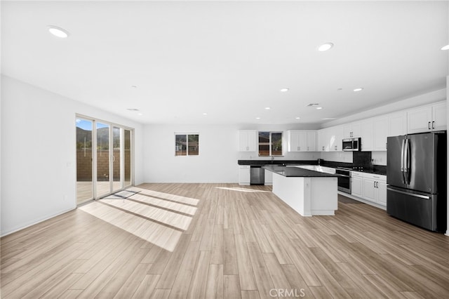 kitchen featuring white cabinetry, light wood-type flooring, and stainless steel appliances