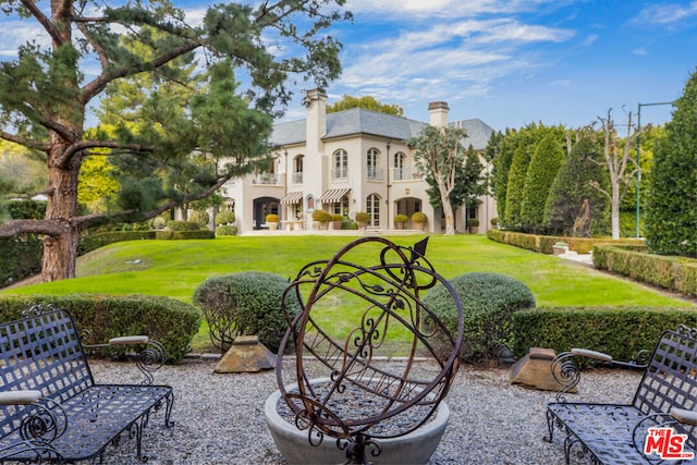 rear view of property with a lawn