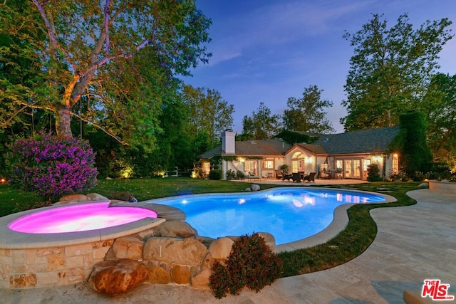 view of swimming pool with an in ground hot tub, a patio area, and a yard