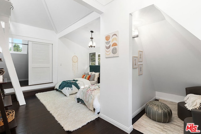 bedroom with a chandelier, vaulted ceiling, dark hardwood / wood-style floors, and multiple windows