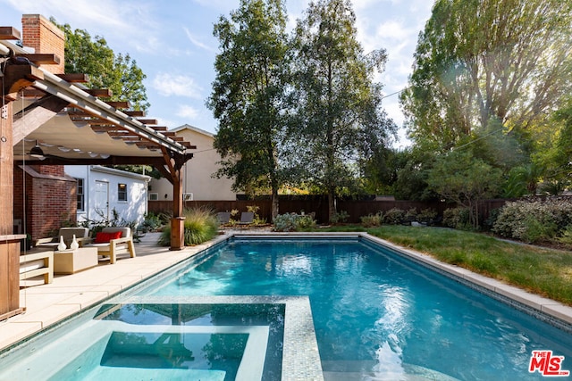 view of swimming pool featuring an in ground hot tub, a patio area, an outdoor structure, and a pergola