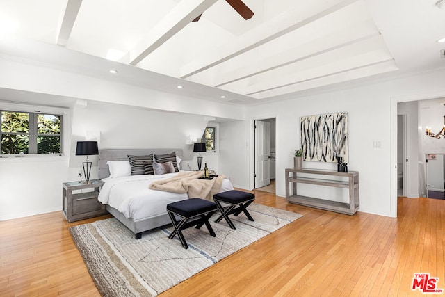 bedroom featuring light hardwood / wood-style floors and ceiling fan with notable chandelier