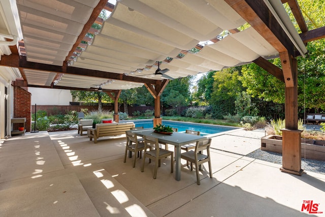 view of patio with ceiling fan and a fenced in pool