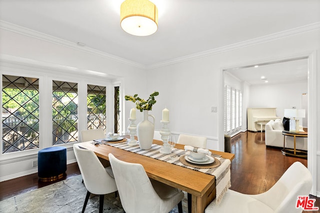 dining area with crown molding and dark hardwood / wood-style floors